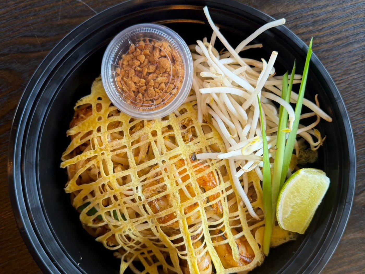 OG Pad Thai wrapped in an egg net at Narwhal Thai Table, Huntington Beach